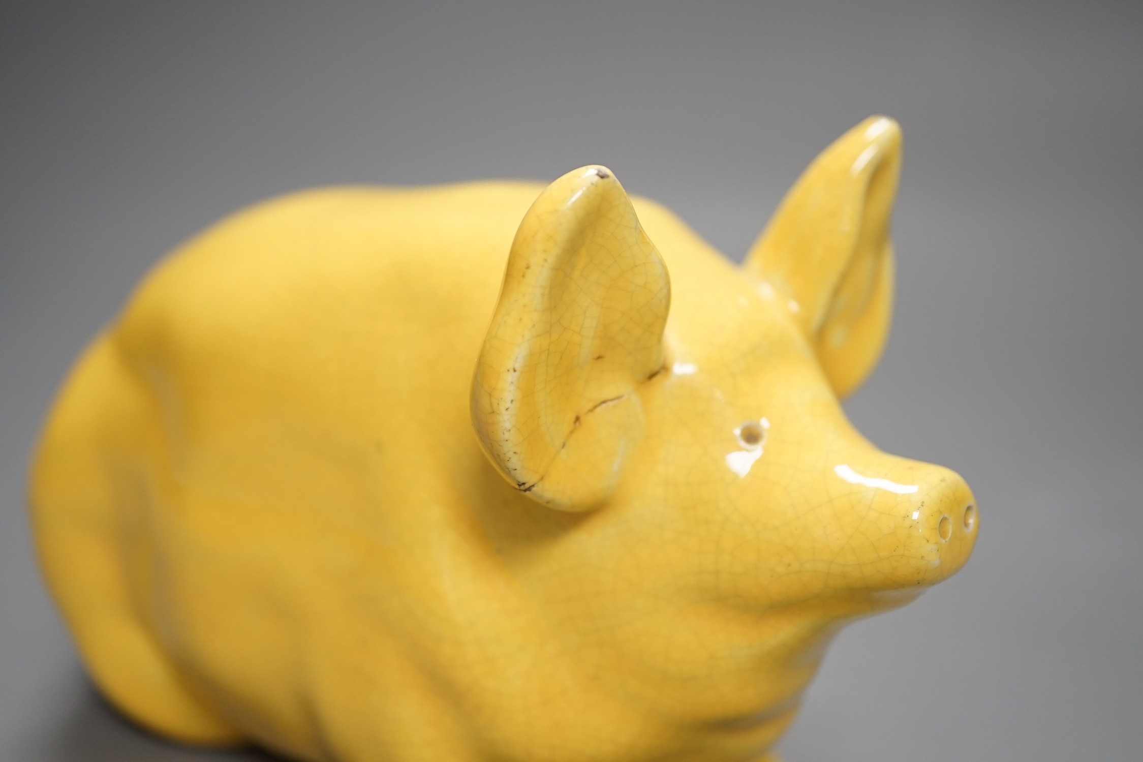 A Wemyss ware yellow glazed pig, 17cms long